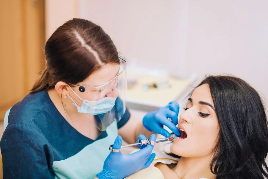 dentist making anaesthetic injection patient